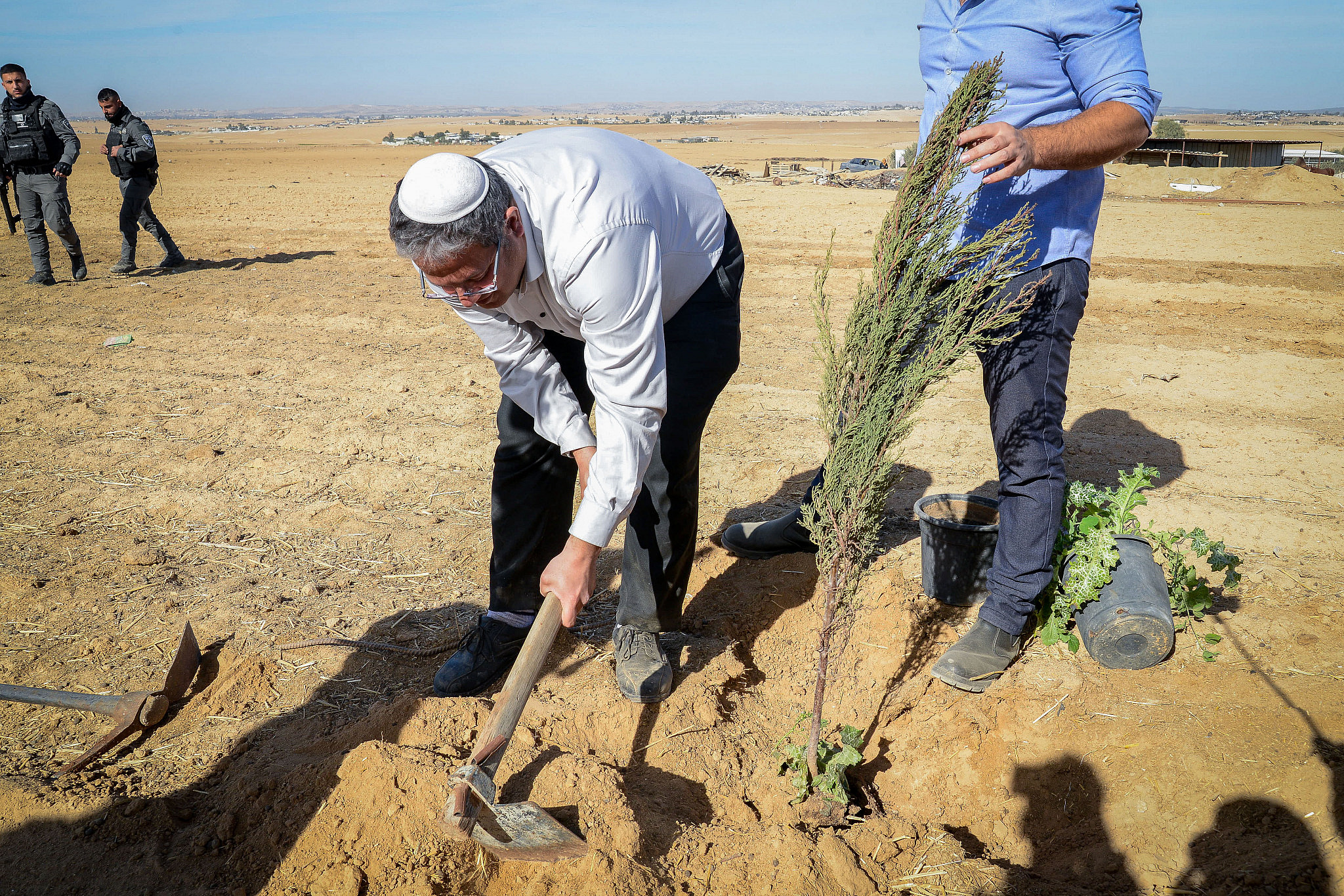 MK Itamar Ben Gvir plants a tree outside the Bedouin village of Sa'wa al-Atrash in the Negev desert, southern Israel, January 12, 2022. (Flash90)