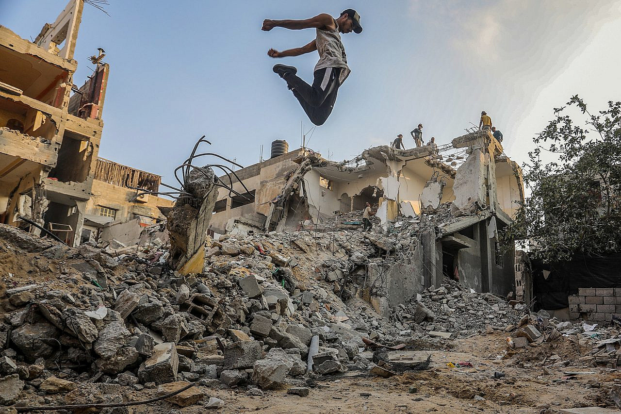 Young Palestinians practice parkour on the rubble of a house in Rafah, southern Gaza Strip, August 20, 2022. (Abed Rahim Khatib/Flash90)