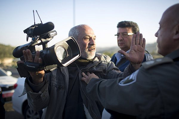Illustrative photo of Israeli police pushing a cameraman in the West Bank. (Oren Ziv/Activestills)