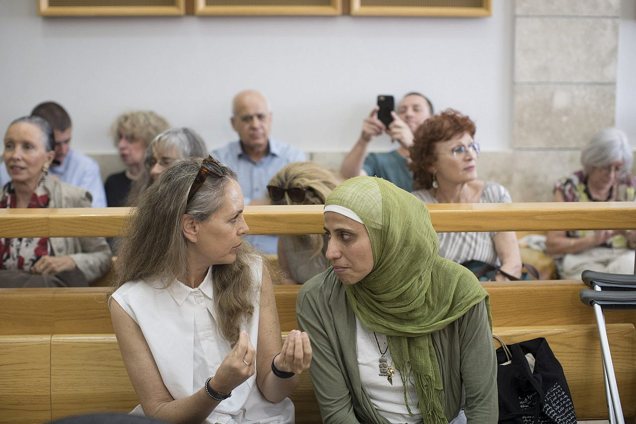 Palestinian poet Dareen Tatour speaks with her lawyer Gaby Lasky before the hearing in her case begins in the Nazareth Magistrate's Court, May 3, 2018. (Oren Ziv/Activestills)