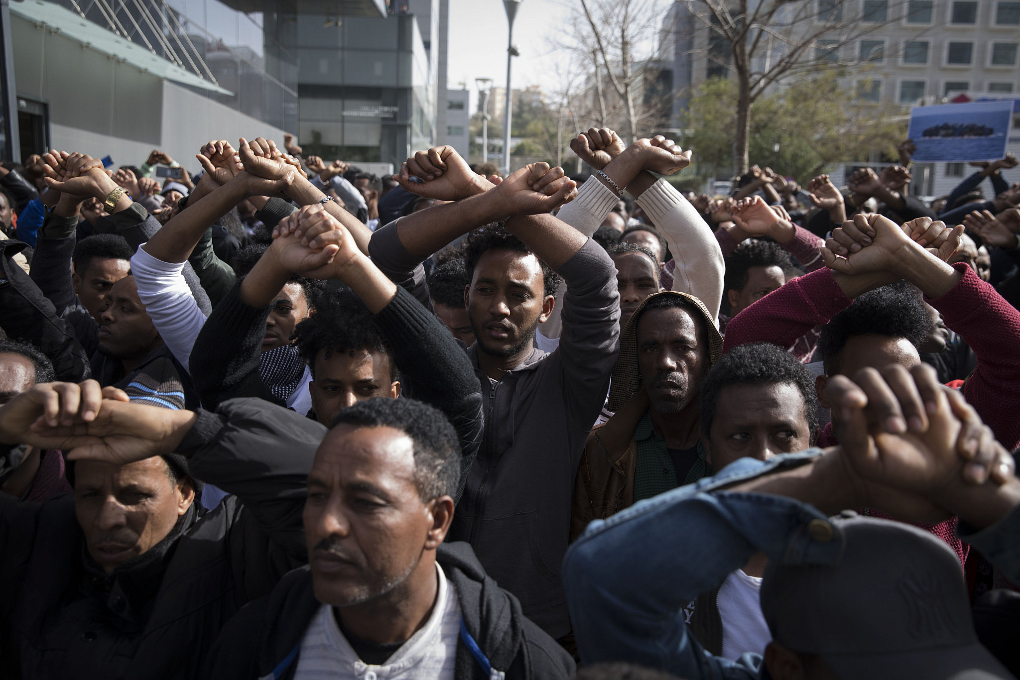 Asylum seekers from Sudan and Eritrea protest outside the embassy of Rwanda in Herzliya, near Tel Aviv, against the Israeli government's plan to deport African asylum seekers to a third-party countries in Africa, January 22, 2018. (Oren Ziv/Activestills)