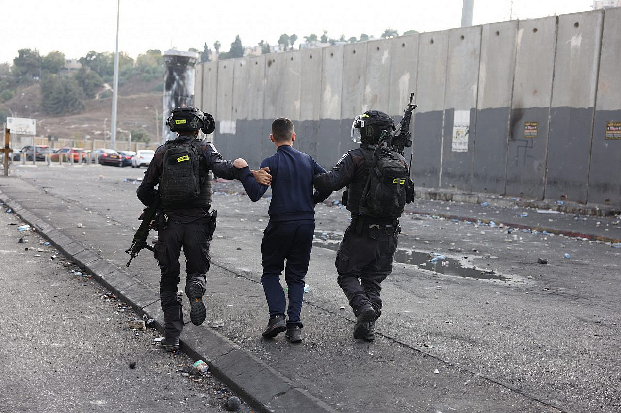 Israeli police detain a young Palestinian during a protest in Shuafat Refugee Camp, occupied East Jerusalem, October 12, 2022. (Oren Ziv/Activestills)