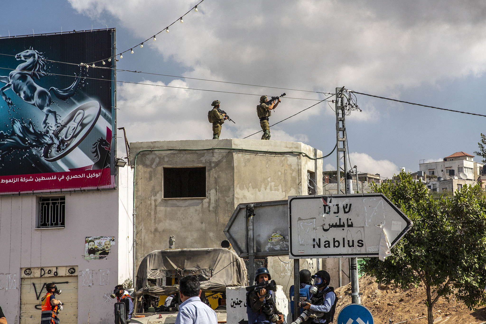 Israeli soldiers are seen on a rooftop during a protest against the closure of the Nablus area, Deir Sharaf, west of Nablus, occupied West Bank, October 20, 2022.