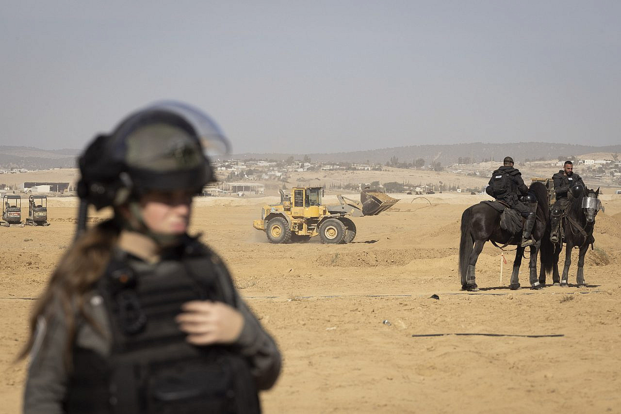 Palestinian Bedouins holding Israeli citizenship try to stop Israeli bulldozers being used in a tree-planting program carried out by the Jewish National Fund (JNF) on the land of the village of Sa’we al-Atrash in the Naqab/Negev desert, January 12, 2022. (Oren Ziv)