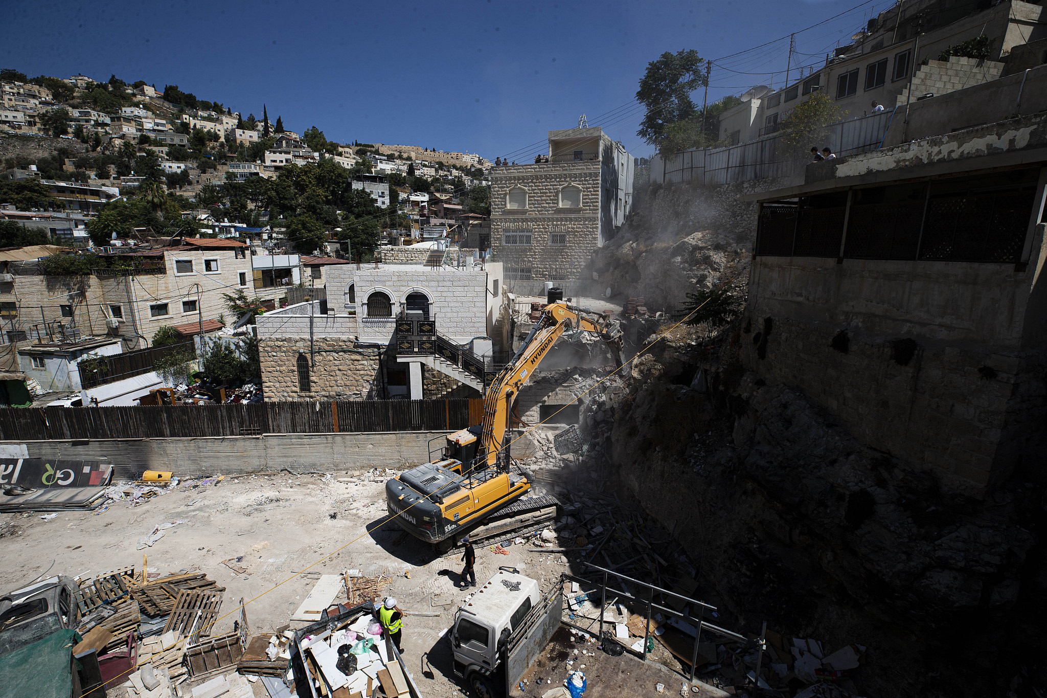 A bulldozer is seen demolishing a building in the Silwan neighborhood of Jerusalem, August 10, 2021. (Activestills)
