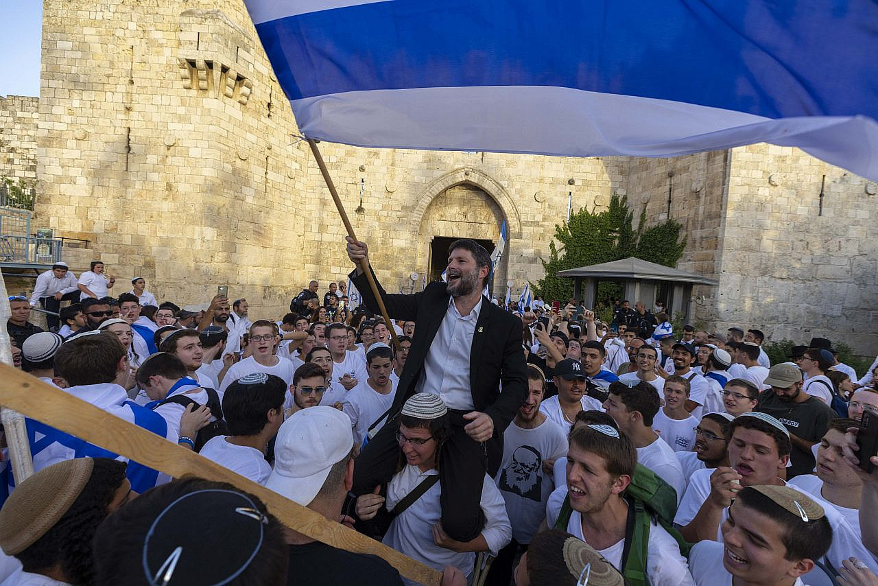 Head of the Religious Zionist Party MK Bezalel Smotrich waves an Israeli flag at Damascus Gate in Jerusalem's Old City, during Jerusalem Day celebrations, May 29, 2022. (Olivier Fitoussi/Flash90)