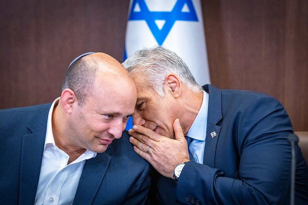 Israeli Prime Minister Yair Lapid with former Prime Minister Naftali Bennett at a cabinet meeting at the Prime Minister's Office, Jerusalem, September 18, 2022. (Olivier Fitousi/Flash90)