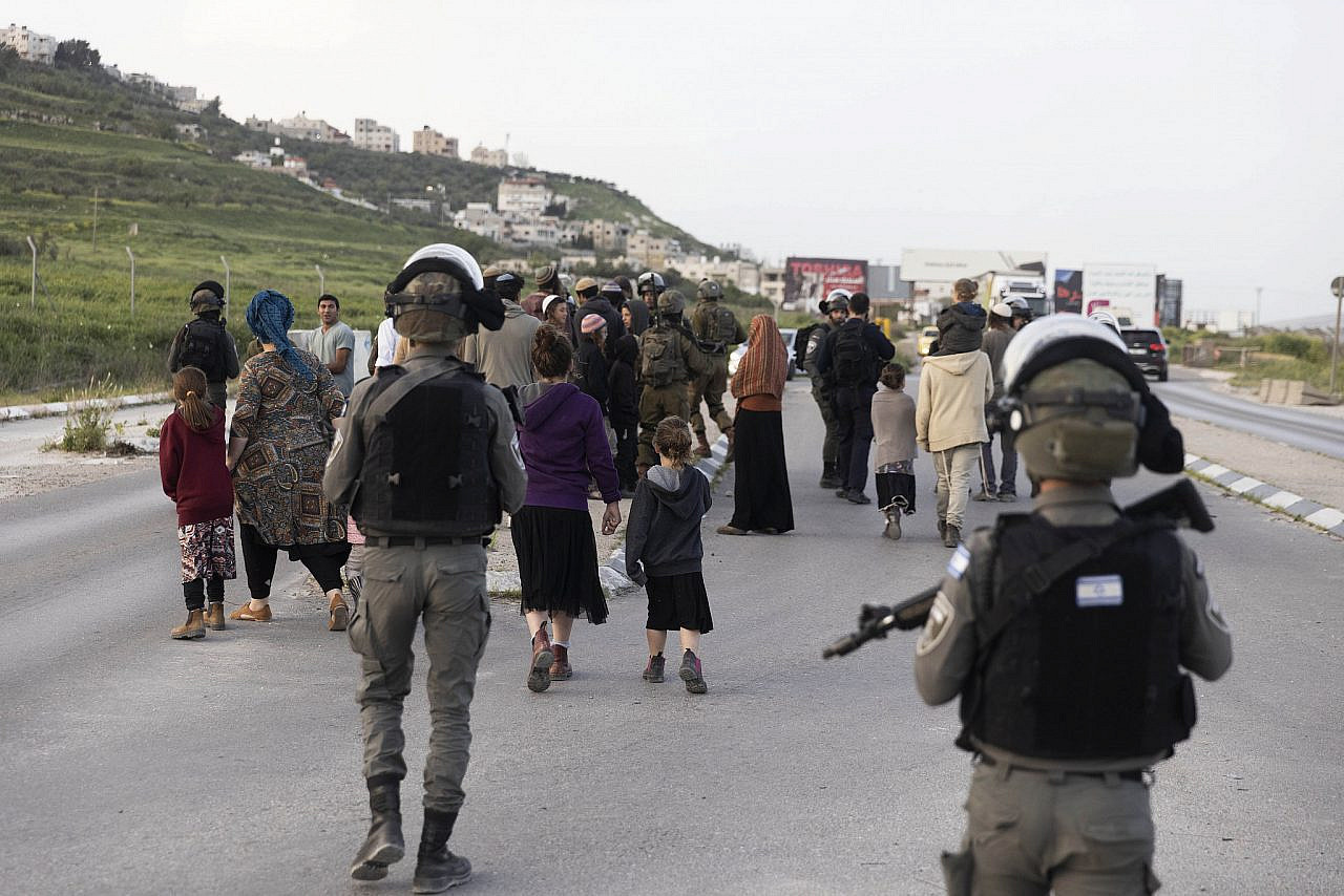 Israeli settlers and soldiers block a main road around Nablus in the occupied West Bank, April 10, 2022. (Oren Ziv)