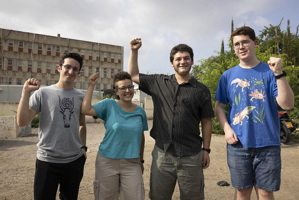 Four Israeli conscientious objectors (left to right) Evyatar Moshe Rubin, Einat Gerlitz, Nave Shabtay Levin, and Shahar Schwartz, are seen outside the Tel Hashomer induction base before their planned announcement to refuse to enlist in the Israeli army, September 4, 2022. (Oren Ziv)