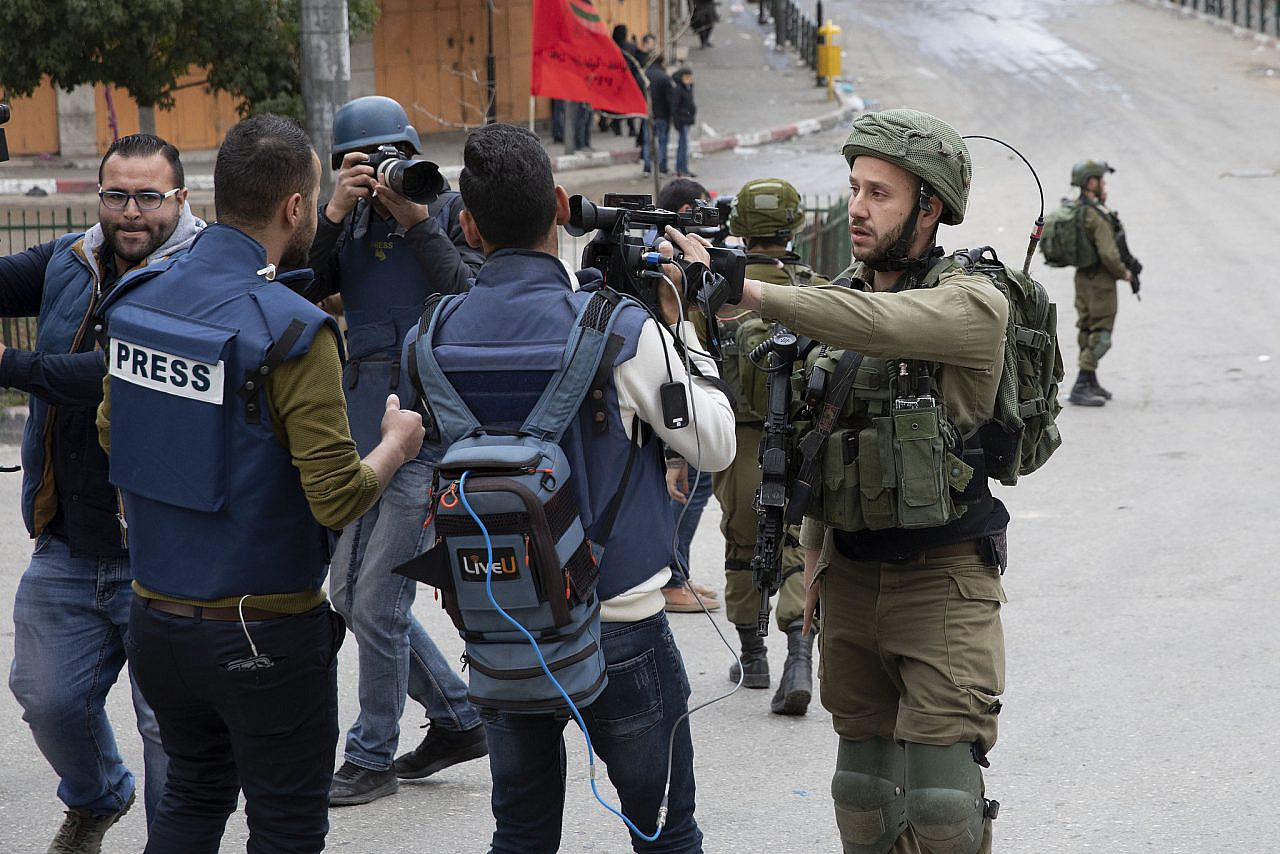 Israeli soldiers block journalists as as hundreds of Palestinian and some Israeli and international demonstrators march in the West Bank city of Hebron calling to open the Shuhada Street, February 20, 2019. (Oren Ziv)