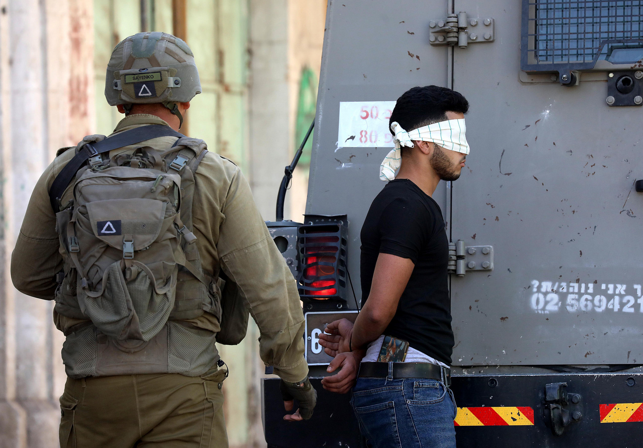 Israeli soldiers arrest a Palestinian youth during clashes between Palestinians and Israeli soldiers in the West Bank city of Hebron, September 9, 2022. (Wisam Hashlamoun/Flash90)