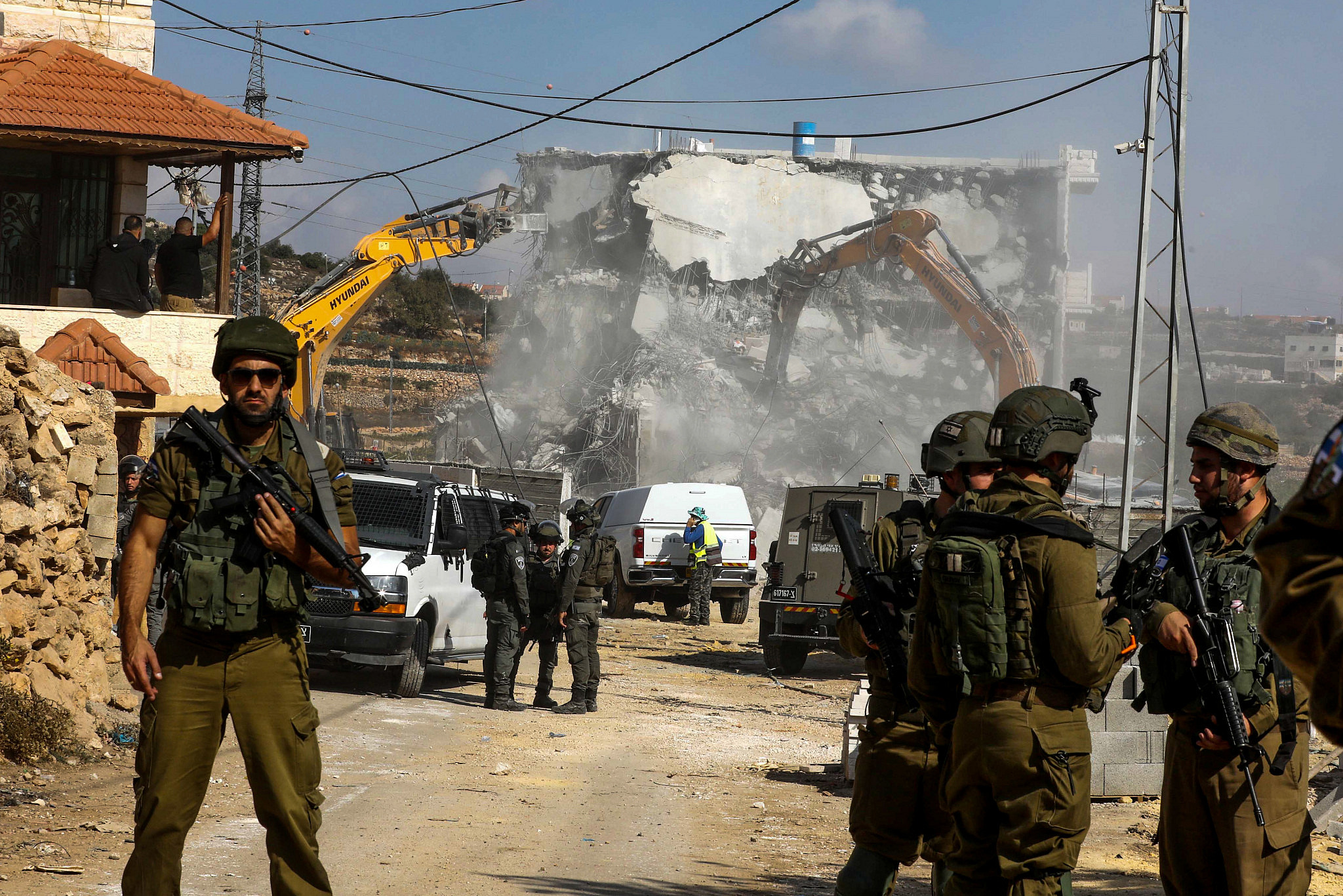 Israeli bulldozers demolish a Palestinian house near the West Bank city of Hebron, October 31, 2022. (Wisam Hashlamoun/Flash90)