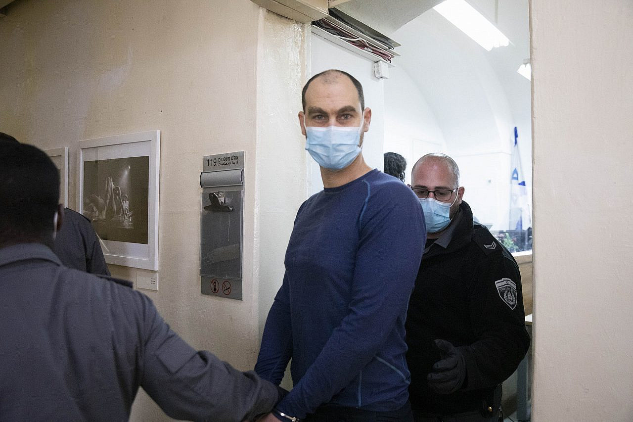 Jonathan Pollak is brought to a hearing in the Jerusalem Magistrate Court after his arrest for his activities against the occupation, March 23, 2021. (Oren Ziv)