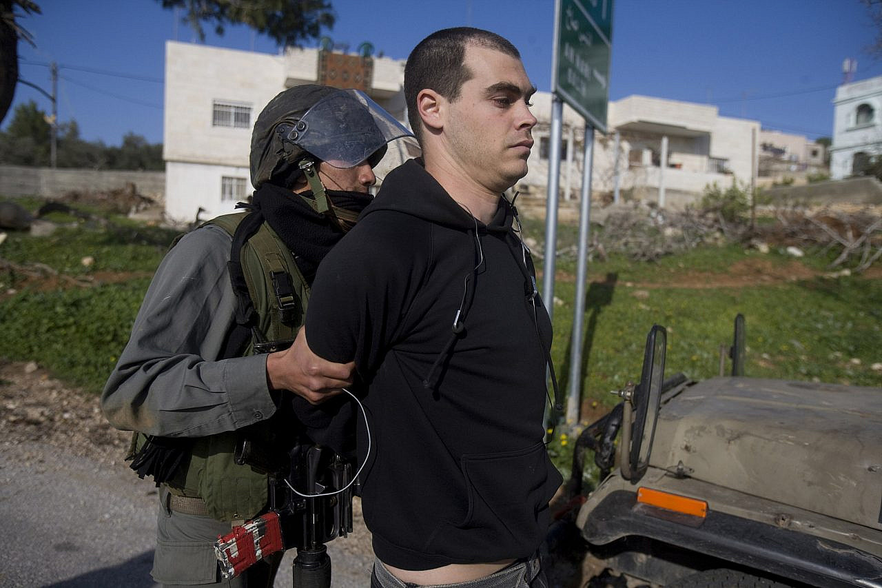 Israeli soldiers arresting Jonathan Pollak during a demonstration in the Palestinian village of Nabi Saleh, occupied West Bank, January 22, 2010. (Oren Ziv)