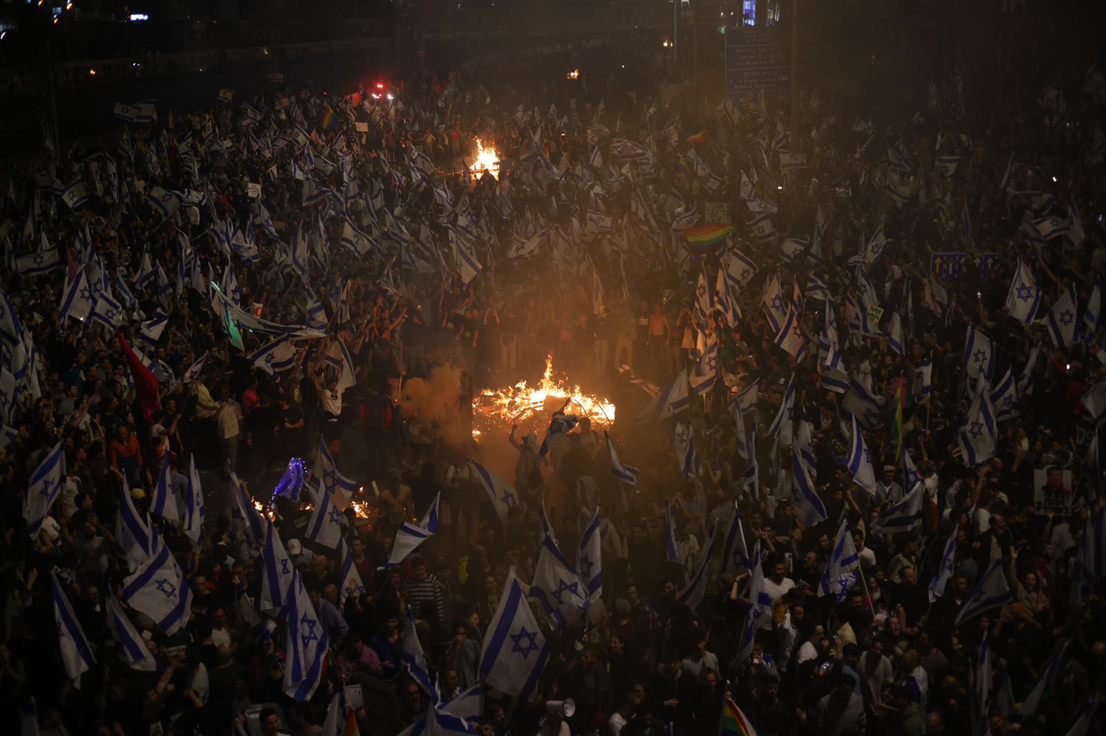 Tens of thousands of demonstrators protest on Ayalon Highway following Prime Minister Benjamin Netanyahu's dismissal of Defense Minister Yoav Gallant, March 26, 2023. (Oren Ziv)