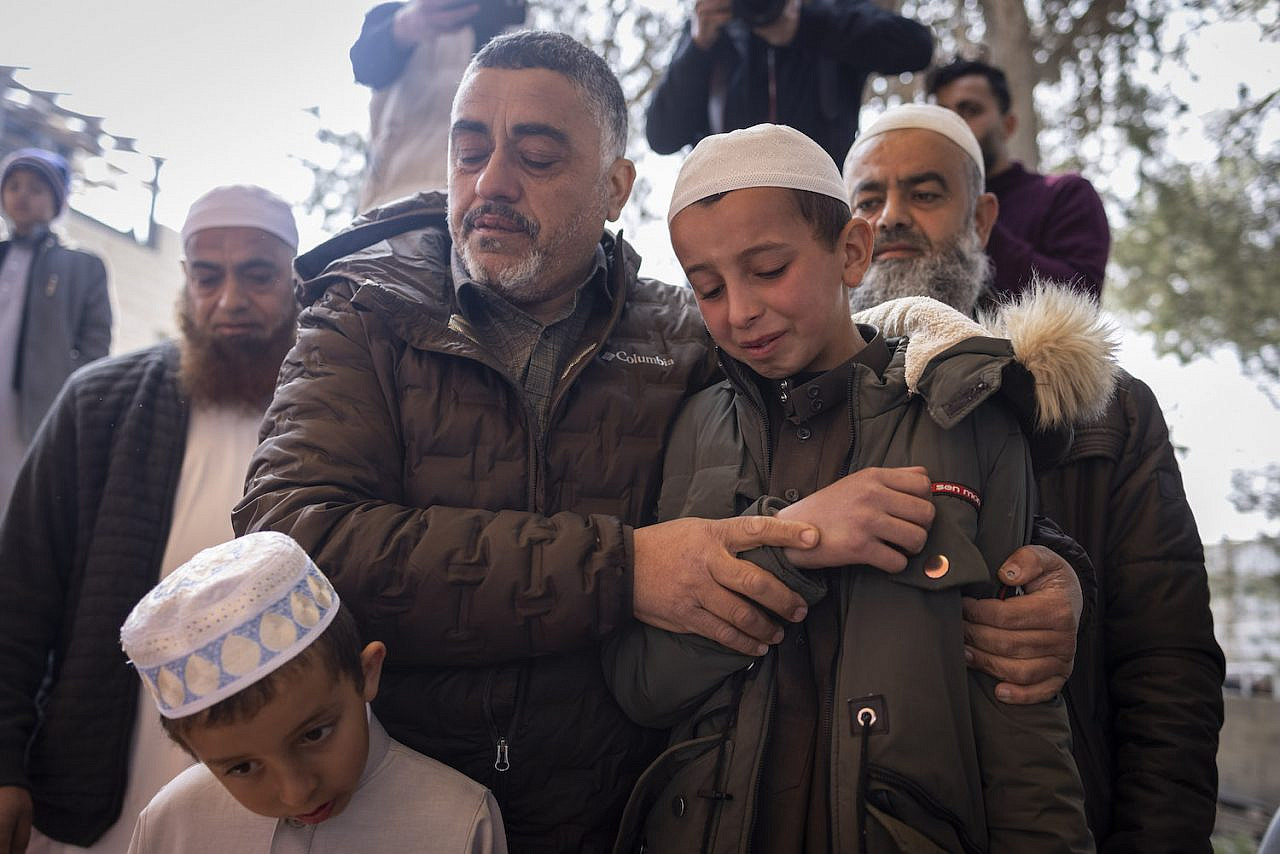 Ayman Aqtesh (left) mourns alongside the children of Sameh Aqtesh, who was killed during the Huwara pogrom, during a visit by European diplomats to the West Bank village of Za'atara, March 3, 2023. (Oren Ziv)