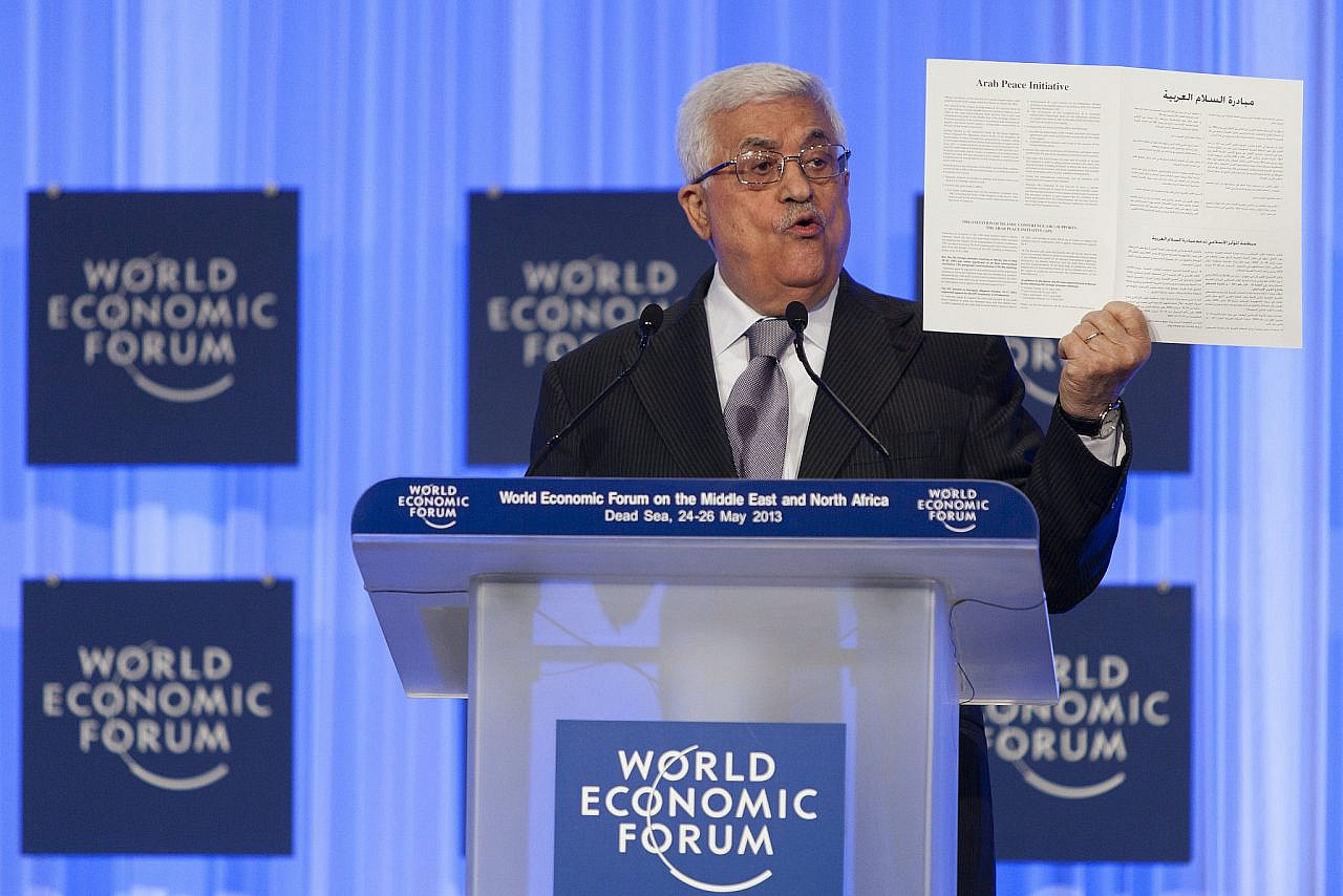 Palestinian President Mahmoud Abbas holds the Arab Peace Initiative document as he speaks at the World Economic Forum on the Middle East and North Africa 2013, Amman, Jordan, May 26, 2013. (Flash90)