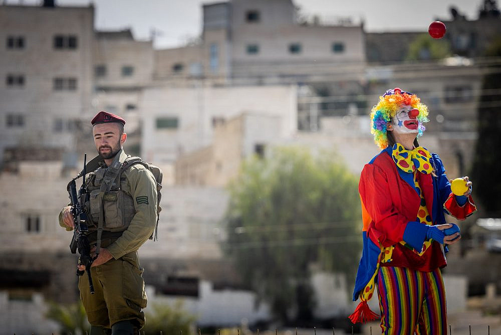 Israeli settlers take part in the annual Purim parade in Hebron, March 7, 2023. (Yonatan Sindel/Flash90)