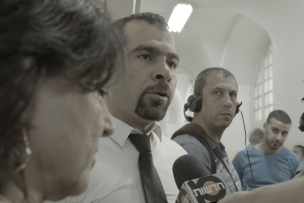 Tareq Barghouth (center) speaks to the Israeli press. (Philippe Bellaïche)