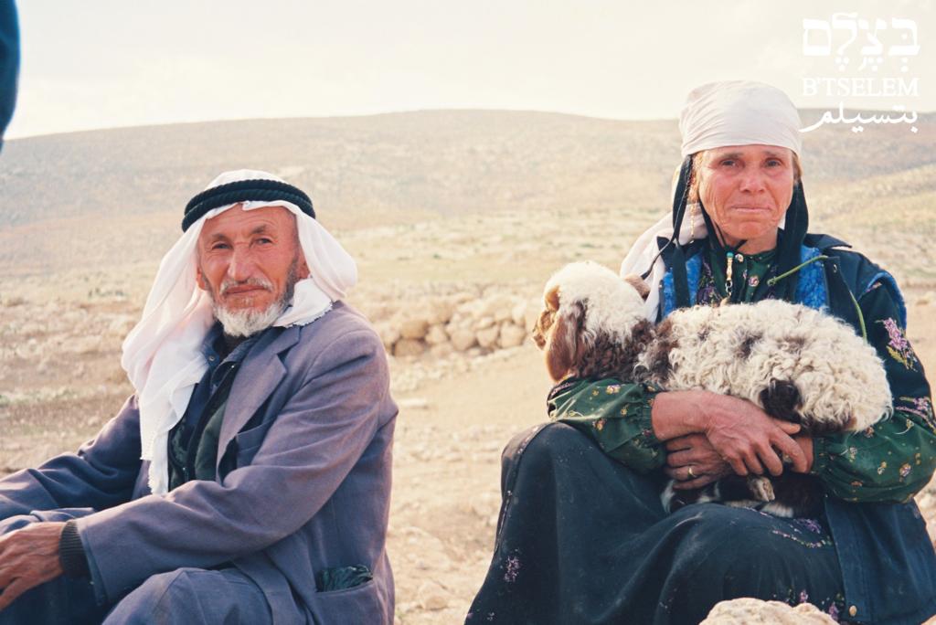 Wadha al-Jabareen holds a lamb during the expulsion of her family from Masafer Yatta in 1999. (Nasrin Elian/B'Tselem)
