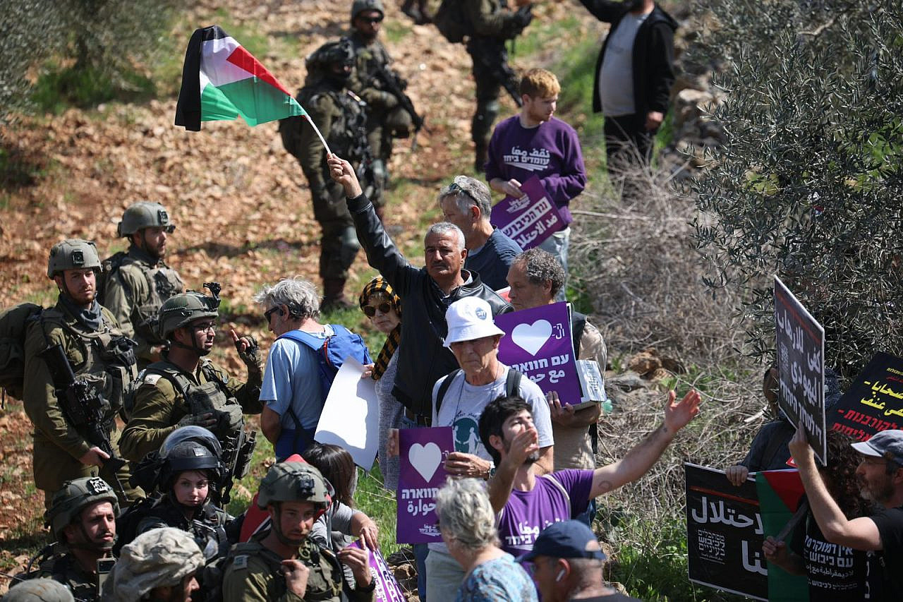 Palestinians and Israelis are stopped by Israeli soldiers during a solidarity visit to the town of Huwara in the West Bank following a settler pogrom there, March 3, 2023. (Oren Ziv)