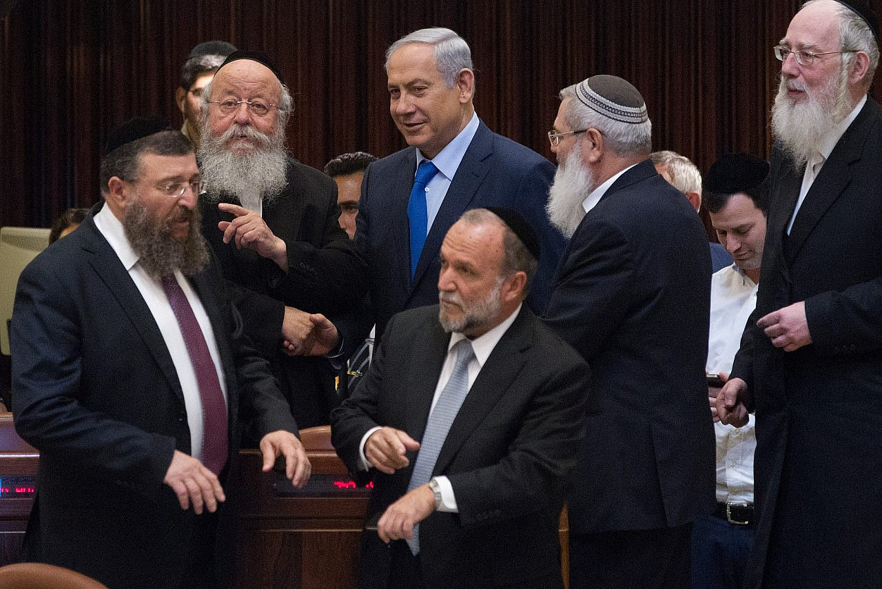 Israeli Prime Minister Benjamin Netanyahu speaks with Haredi parliament members during a Knesset plenum session, November 16, 2015. (Miriam Alsterl/Flash90)