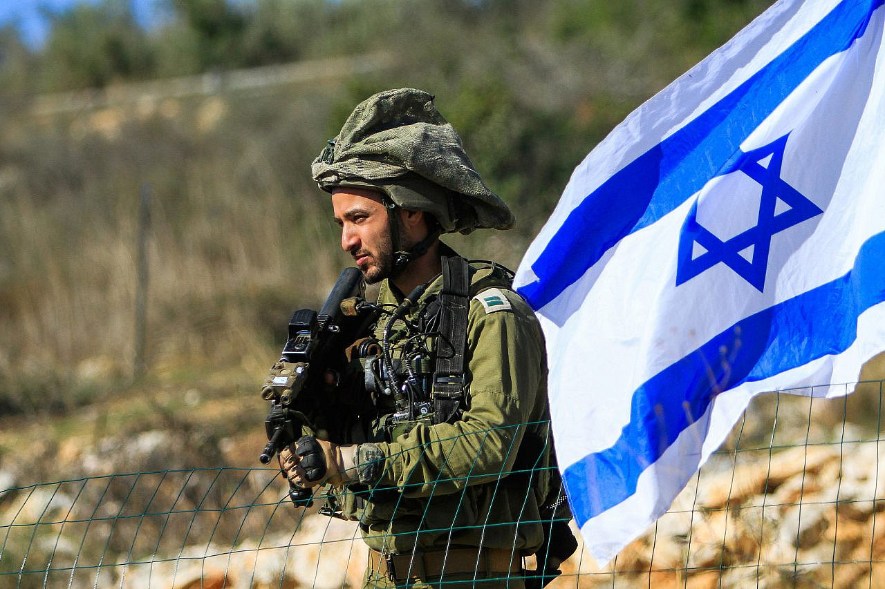 An Israeli soldier seen outside the Palestinian village of Bruqin, West Bank, November 20, 2022. (Nasser Ishtayeh/Flash90)