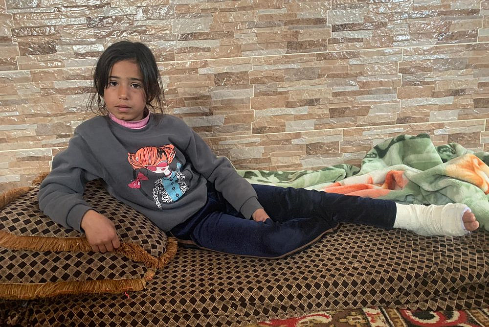Qamar Elian, a Palestinian girl from the West Bank village of Umm Lasafa, in her home after an Israeli soldier kicked and broker her ankle while her family approached their private land. (Basil Adra)