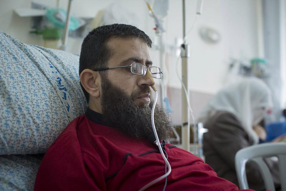 Palestinian Khader Adnan, receiving hospital treatment after concluding a 56-day hunger strike against his administrative detention in Israeli prison, East Jerusalem, July 16, 2015. (Faiz Abu Rmeleh/Activestills)