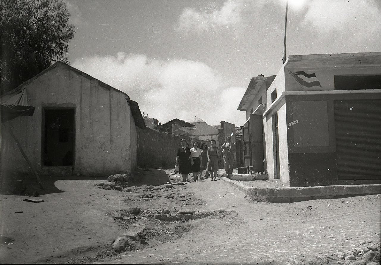 Mizrahi immigrants walk through the streets of Salama after the village's Palestinians were expelled, April 1948. (Benno Rothenberg /Meitar Collection / National Library of Israel / The Pritzker Family National Photography Collection)