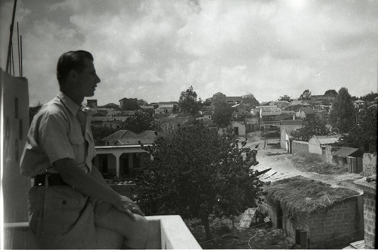 An Israeli soldier looks out over the Palestinian village of Salama, April 25, 1948. (Benno Rothenberg /Meitar Collection / National Library of Israel / The Pritzker Family National Photography Collection)