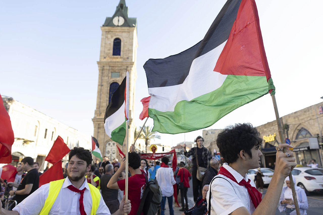 Young protesters from Banki wave Palestinian flags at a May Day demonstration in Jaffa, May 1, 2023. (Oren Ziv)