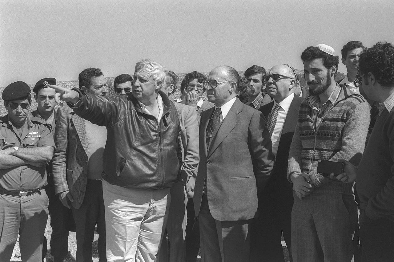 Prime Minister Menachem Begin and Interior Minister Yosef Burg receive explanations from Agriculture Minister Ariel Sharon about the Elon Moreh settlement in the West Bank, February 27, 1981. (Chanania Herman/GPO)