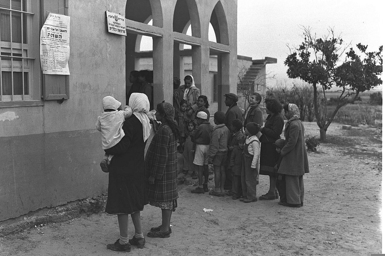 Mizrahi immigrants line up at the anti-tuberculosis station in Kfar Shalem, January 1, 1950. (Fritz Cohen)