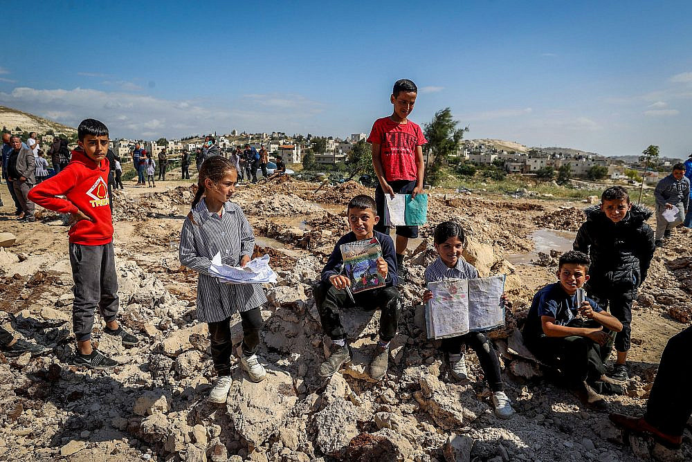 Palestinians inspect the rubble of the elementary school in Jib al-Dib, an unrecognized village in the occupied West Bank, after Israeli authorities demolished it on May 7, 2023. (Flash90)