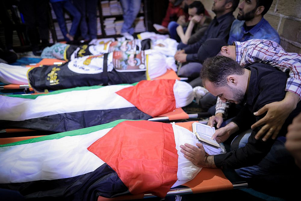 Mourners bid farewell to Palestinian-Russian doctor Jamal Kheshwan and his son ahead of their burial in Gaza City, following early morning Israeli air strikes on the Palestinian territory, May 9, 2023. (Atia Mohammed/Flash90)