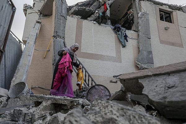Palestinians outside a destroyed house after an Israeli air strike, in Khan Yunis, in the southern Gaza Strip, May 13, 2023. (Abed Rahim Khatib/Flash90)