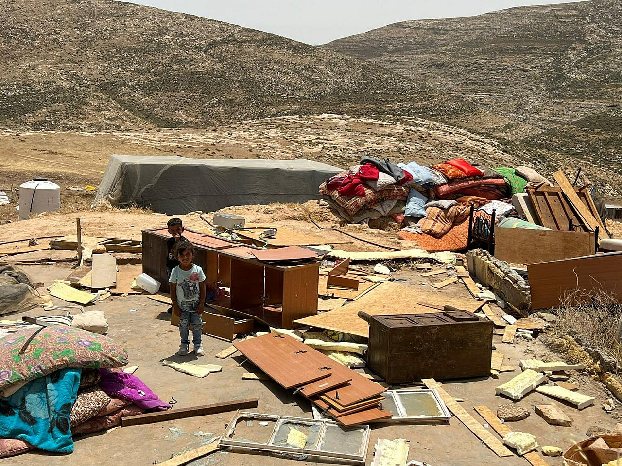  The belongings and remains of homes of Palestinian families in ‘Ein Samia, occupied West Bank, May 23, 2023. (Basel Adra)