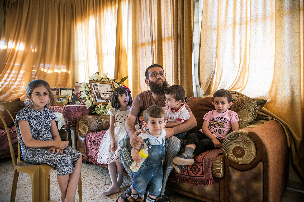 Khader Adnan with his family at home in Arraba, near Jenin in the occupied West Bank, August 12, 2015. (Ahmad al-Bazz/Activestills.org)