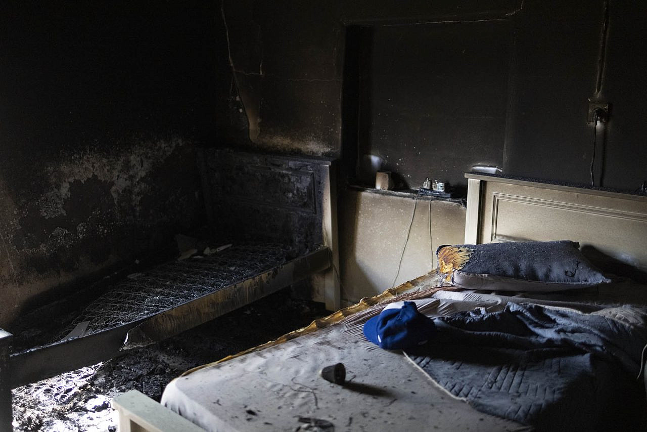 A bedroom in a home that settlers set on fire during an attack on Turmus Ayya in the occupied West Bank, June 22, 2023. (Oren Ziv)