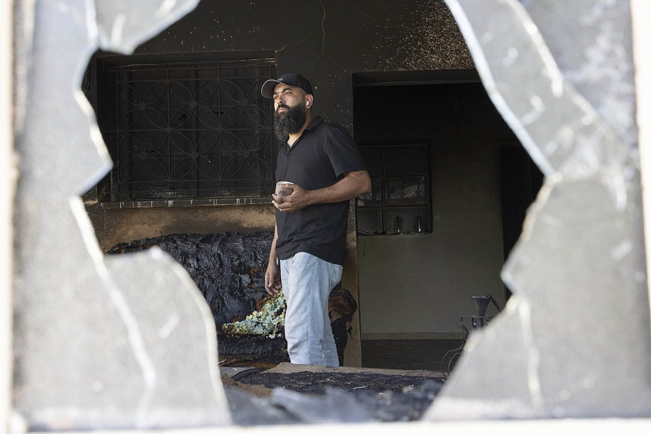 Bilal Hijaz, 38, stands in his home after it was set on fire by settlers during an attack on Turmus Ayya in the occupied West Bank, June 22, 2023. (Oren Ziv)