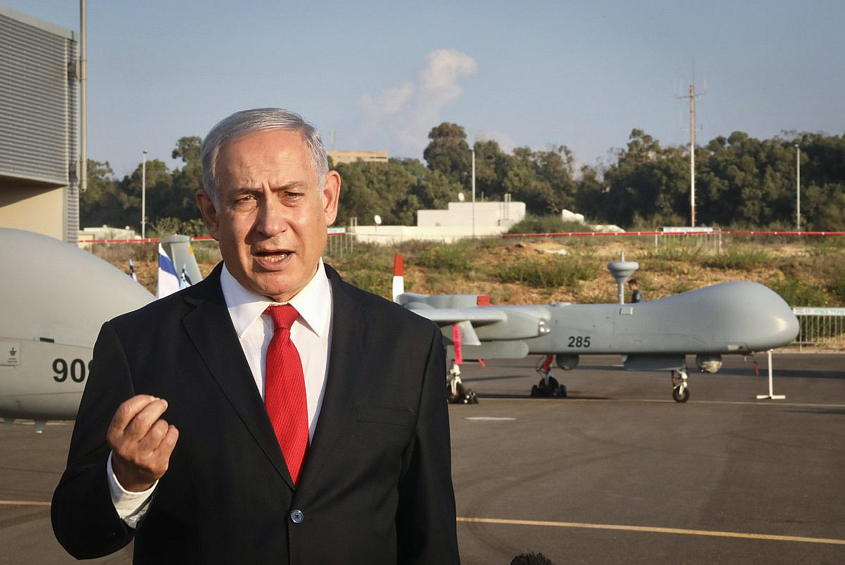 Prime Minister Benjamin Netanyahu speaks to media in front of a killer drone during a security tour of the Palmachim Airbase, October 27, 2019. (Marc Israel Sellem/Flash90)