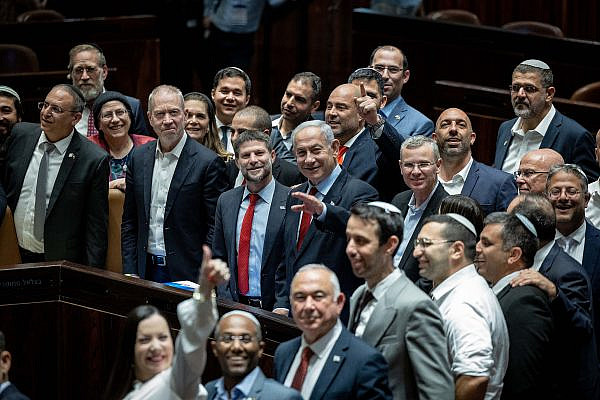 Israeli Prime Minister Benjamin Netanyahu, surrounded by members of his government, seen after a hearing and a vote on the state budget in the Knesset, Jerusalem, May 23, 2023. (Yonatan Sindel/Flash90)