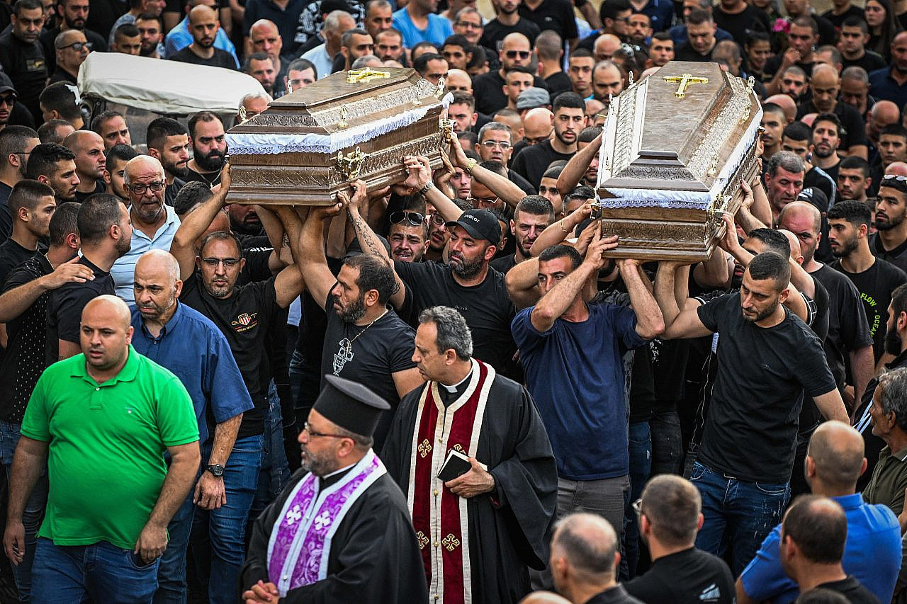 Mourners carry the coffins of two of the five men who were murdered last week in the Palestinian village of Yafa an-Naseriyye, northern Israel, June 9, 2023. (Flash90)