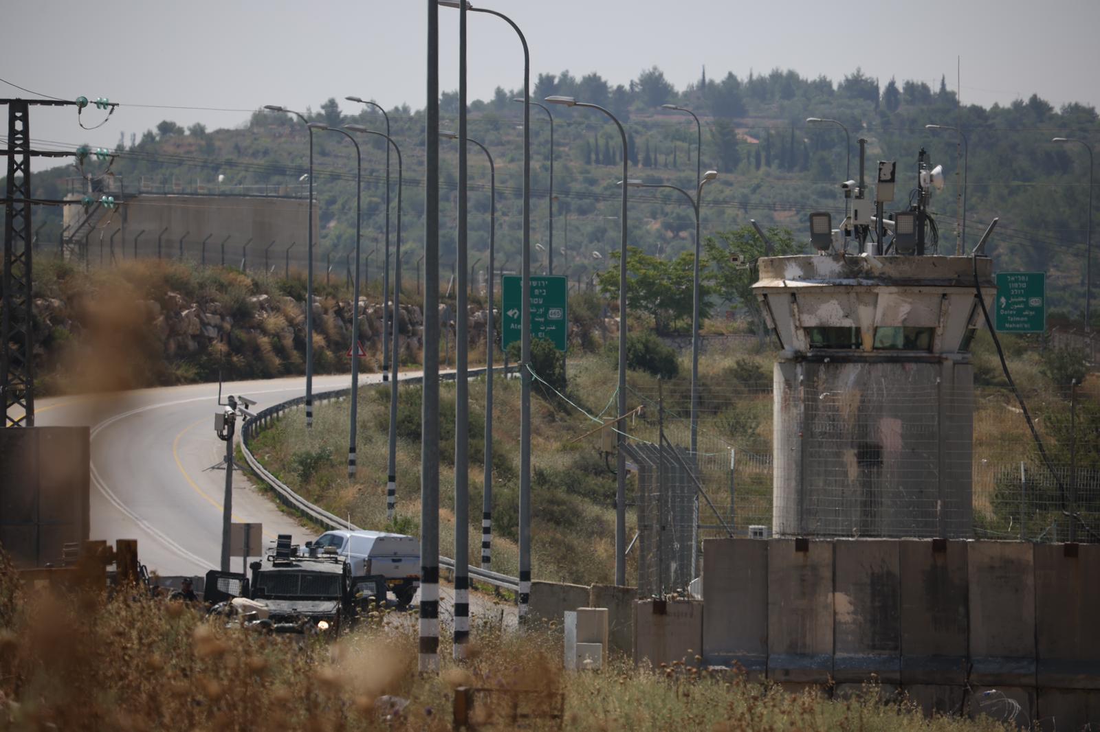 View of the Israeli army post at the entrance of the village of Nabi Saleh during the funeral of two-year-old Mohammed Tamimi, June 6, 2023. (Oren Ziv)