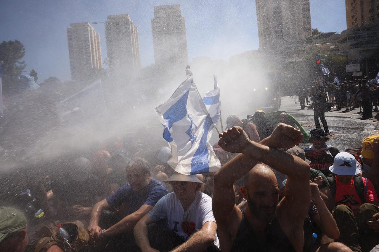Israeli police use a water cannon against anti-government protesters outside the Knesset, Jerusalem, July 24, 2023. (Oren Ziv)