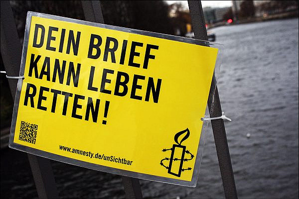Campaign by Amnesty International and Mentalgassi on 'Making the invisible visible,' with the German poster reading 'Your letter can save lives,' Berlin, Germany, December 9, 2011. (Steffi Reichert/CC BY-NC-ND 2.0)