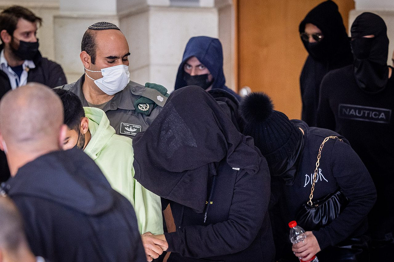 The Border Police officer accused of killing Iyad al-Hallaq in the Old City of Jerusalem is seen leaving the Jerusalem District Court with his face covered after a hearing on the case, February 27, 2022. (Yonatan Sindel/Flash90)