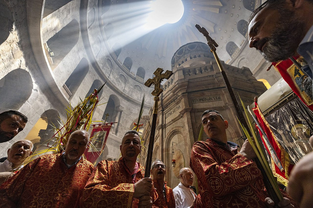 Orthodox Christian church leaders lead their communities' processions on Palm Sunday, in the Church of the Holy Sepulchre, in Jerusalem's Old City, April 17, 2022. (Olivier Fitoussi/Flash90)