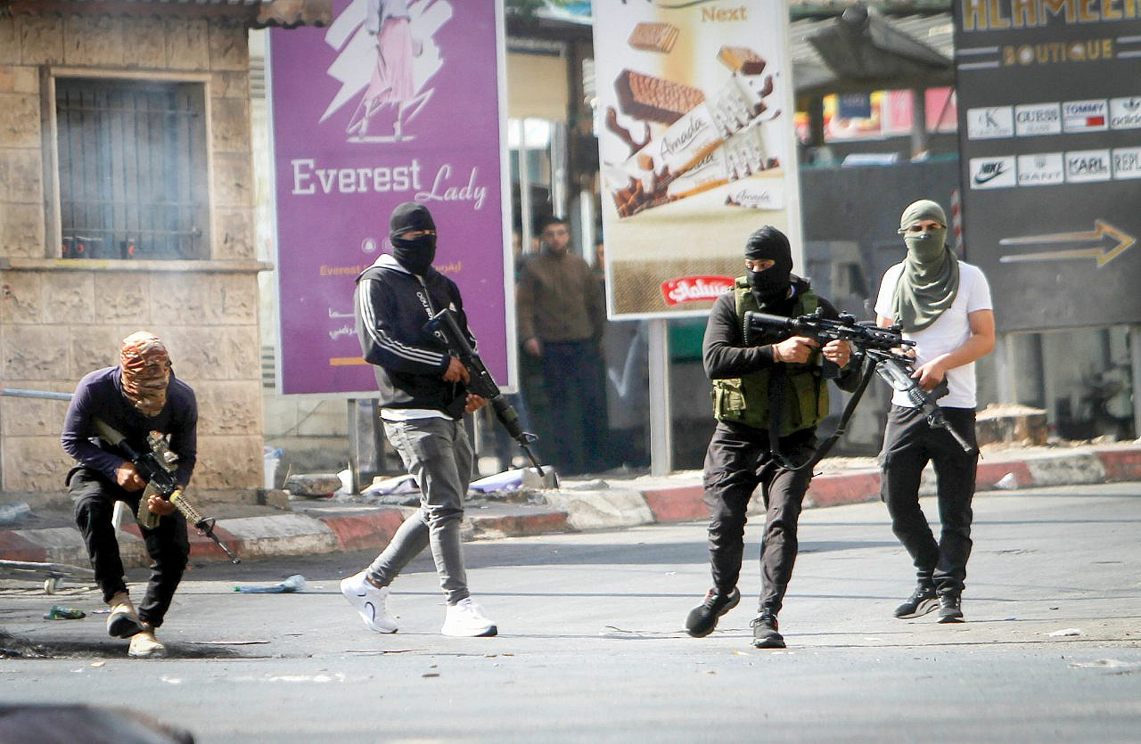 Armed Palestinian men confront Israeli forces during a major Israeli aerial and ground offensive inside Jenin refugee camp, occupied West Bank, July 3, 2023. (Nasser Ishtayeh/Flash90)